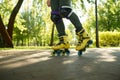 Closeup boy legs wearing roller skates over green nature of urban park Royalty Free Stock Photo