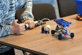 Closeup of boy`s hands pumping up the constructor and learning the basics of pneumatics at school. Robotics, STEM Royalty Free Stock Photo