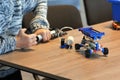 Closeup of boy`s hands pumping up the constructor and learning the basics of pneumatics at school. Robotics, STEM