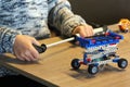 Closeup of boy`s hands pumping up the constructor and learning the basics of pneumatics at school. Robotics Royalty Free Stock Photo