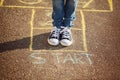 Closeup of boy`s legs and playing hopscotch on playground outdoors. Hopscotch popular street game Royalty Free Stock Photo