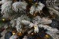 Branches on an artificial Christmas tree flocked with snow