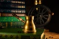 Closeup brass turk with beans beside and coffee grinder on background. Atmosphere of old library with old books around on dark Royalty Free Stock Photo