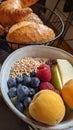 Breakfast consisting of porridge with fruits and berries and different types of bread Royalty Free Stock Photo