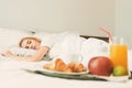 Closeup of breakfast in front of sleeping woman