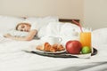 Closeup of breakfast in front of sleeping woman