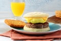 Closeup breakfast sausage egg cheese waffles sandwich on a blue plate Royalty Free Stock Photo