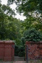 Closeup of a brick fence and gate in a green park in Cottbus, Germany