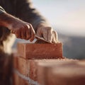 Closeup of a bricklayer carefully laying bricks with a trowel, representing construction, hard work, and building progress. Ideal Royalty Free Stock Photo