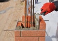 Closeup of a Bricklayer Worker Installing Red Blocks. Bricklaying. Royalty Free Stock Photo
