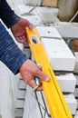 A closeup of a bricklayer worker installing wite blocks and caulking brick masonry joints exterior wall with trowel putty knife ou Royalty Free Stock Photo