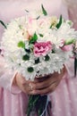 Closeup bridal bouquet of spring pink and white flowers on a blurred background, selective focus Royalty Free Stock Photo
