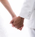 Closeup of bride and groom holding hands isolated on white back Royalty Free Stock Photo