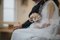 Closeup of a bride and groom sitting next to each other in church