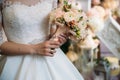 Closeup of bride hands holding beautiful wedding bouquet with white and pink roses. Concept of floristics Royalty Free Stock Photo