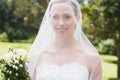 Closeup of bride wearing veil in garden Royalty Free Stock Photo