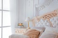 Closeup of Bright White Bedroom Interior with night table lamp and window