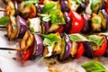closeup of brightly lit eggplant skewers on parchment paper