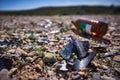 Closeup of broken glass and a beer bottle lying on the ground Royalty Free Stock Photo