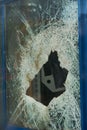 Closeup of a broken glass window, a vertical shot Royalty Free Stock Photo