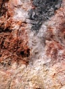 Closeup of a broken stone which contains various colored mineralsvarious