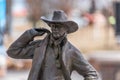 Closeup of a bronze cowboy on a blurry background