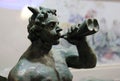 Closeup of a bronze statue blowing a horn