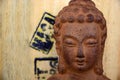 Closeup of brown Buddha statue against a wooden background Royalty Free Stock Photo