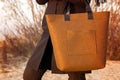 Closeup of brown felt bag in woman hand