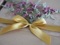 Brown paper gift box tied with a golden ribbon and decorated with dried flowers, Festival Gifts for Christmas and Happy New Year Royalty Free Stock Photo