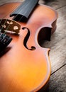 Closeup Brown Violin On Wooden Background. Art And Music Background.