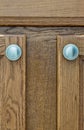 Brown rustic wooden cupboard doors with silver handles. Royalty Free Stock Photo