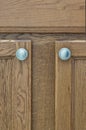 Brown rustic wooden cupboard doors and handles. Royalty Free Stock Photo