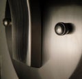 Abstract face in closeup of brushed nickle metal sconce. Royalty Free Stock Photo