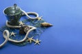 Closeup of bucket, amrine rope and net, seashell on the blue background.Empty space for design