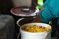 Closeup of a bucket of cooked threshed corn for the preparation of Columbian arepas