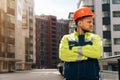 Closeup of a builder engineer holding a helmet with his hand. A man wants to take off his special helmet Royalty Free Stock Photo