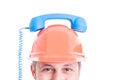 Closeup of builder holding retro receiver on helmet Royalty Free Stock Photo