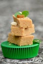 closeup the bunch brown color condensed milk sweet with green mint and pea nut,sesame grain,drilled grapes soft focus grey brown