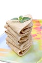 closeup the bunch brown color tortilla with green mint in the yellow white plastic tray on the white background