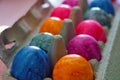 Closeup of a bunch of multi-colored boiled eggs in a package for easter