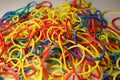 Closeup of a bunch of multicolored elastic rubber bands scattered on the table