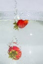 Closeup of Bunch of Strawberries With Water Splashes In Aquarium