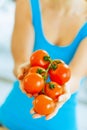 Closeup on bunch of tomato in hand of young woman Royalty Free Stock Photo