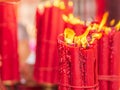 Bundle of big red candles burning near the golden tray at Longshan temple with copy space.