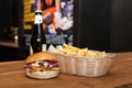 Closeup of a burger with French fries and beer on a table Royalty Free Stock Photo