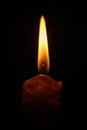 Closeup of burning candle isolated on black background Royalty Free Stock Photo
