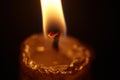 Closeup of burning candle isolated on black background Royalty Free Stock Photo