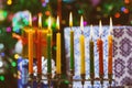 Closeup of a burning Chanukah candlestick with candles Menorah