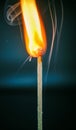 Closeup of burning match with red sulfur head on dark background Royalty Free Stock Photo